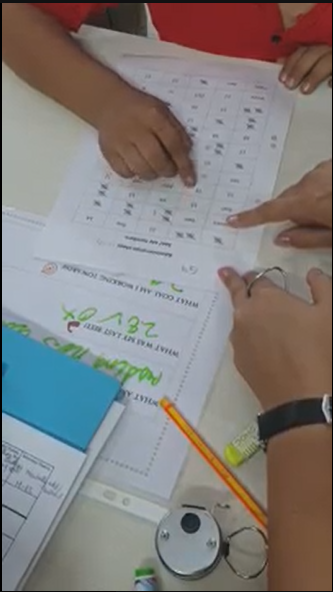 Child working through a math fluency worksheet