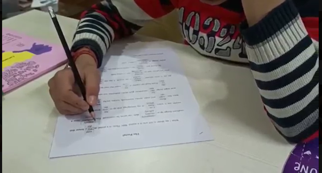Child completing a written assessment task